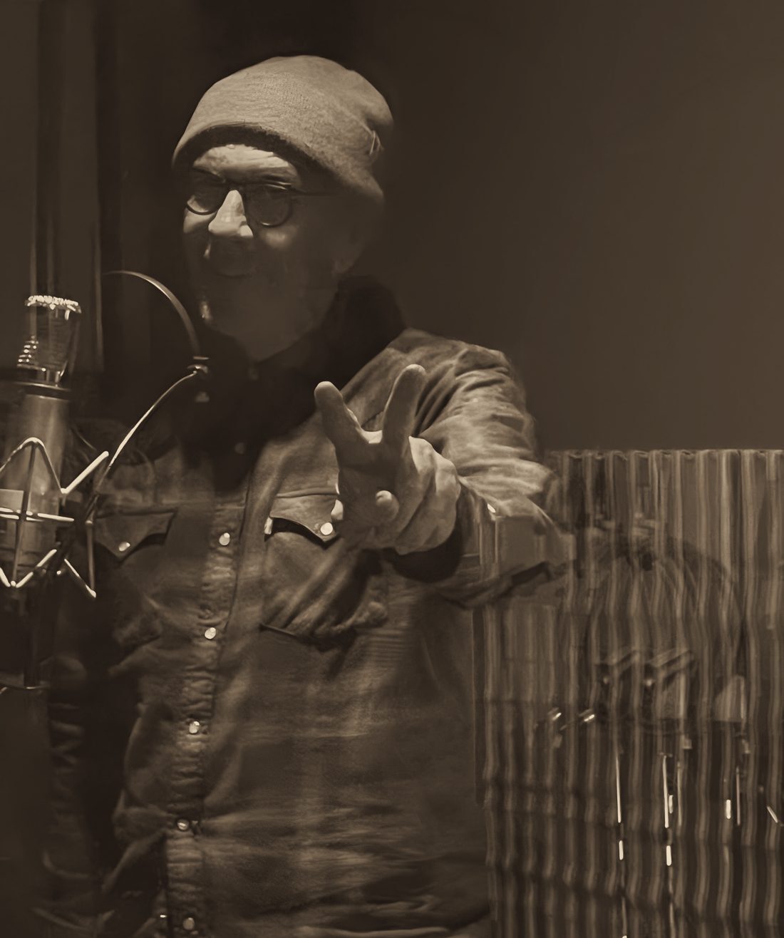Ross Gilchrist singing into a studio microphone