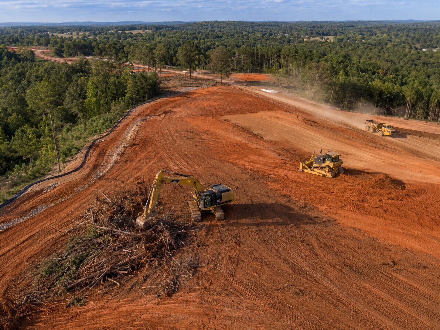 Drone aerial view of land clearing and dirt work in progress on an Alabama site