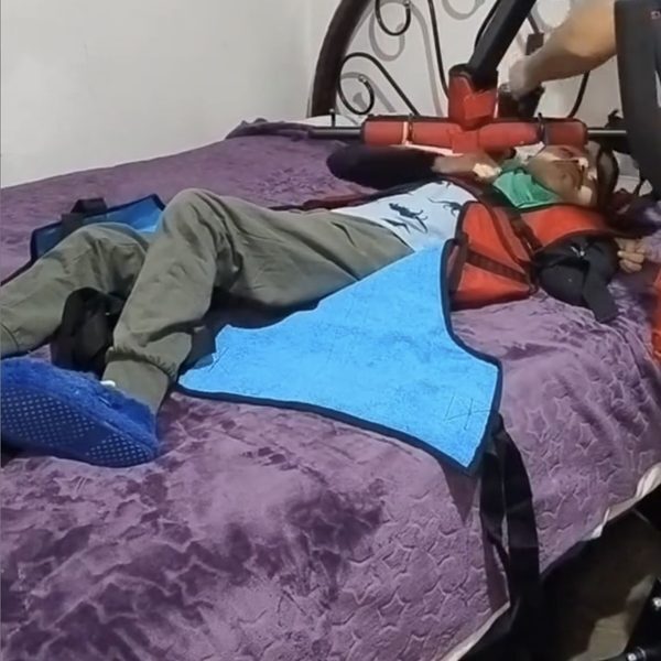 Colocando el arnés a Iker en su cama